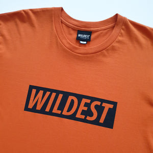 Close up of orange t shirt with black Wildest block print