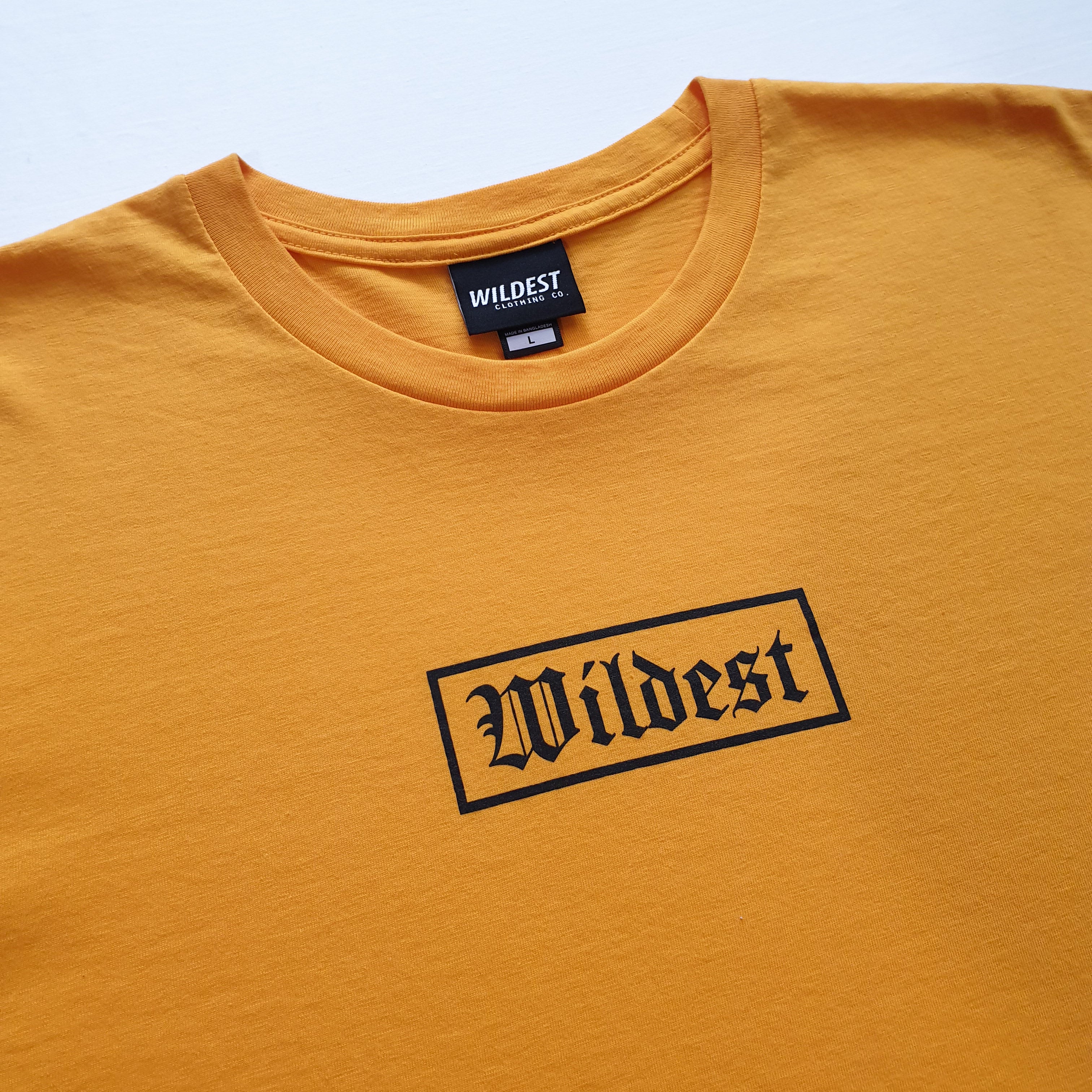 Close up of gold t shirt with black Wildest blackletter box print