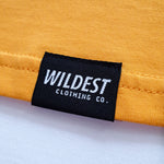 Close up of Wildest Clothing Co. brand tag on the bottom hem