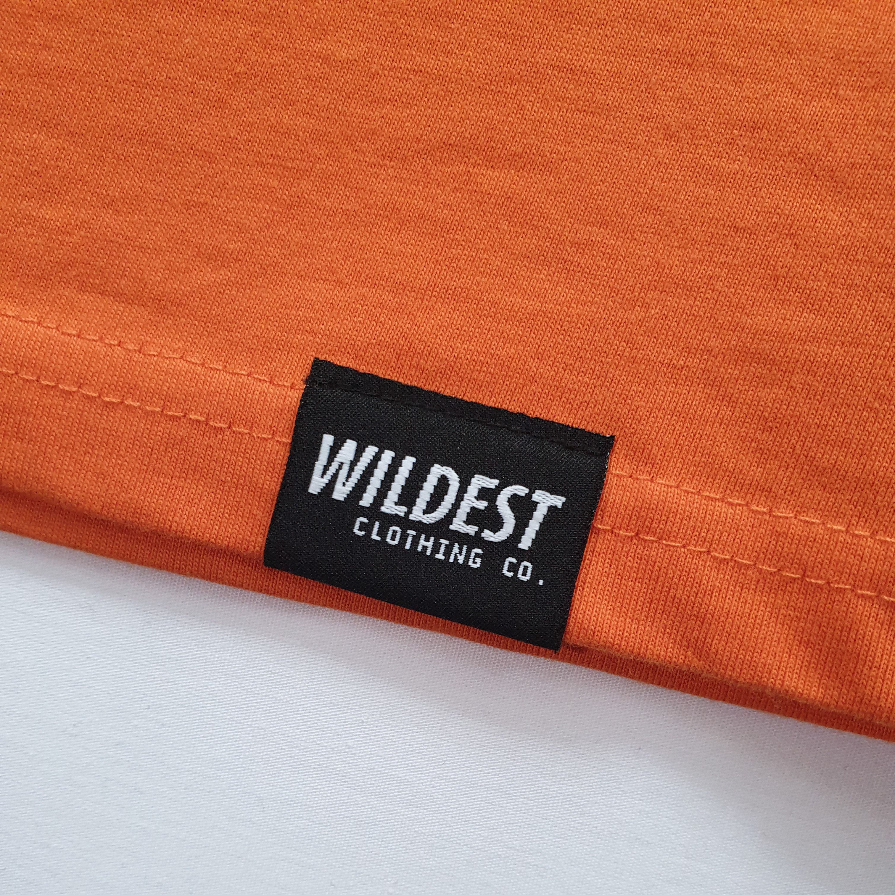 Close up of Wildest Clothing Co. brand tag on the bottom hem