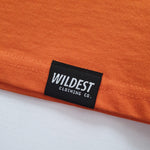 Close up of Wildest Clothing Co. brand tag on the bottom hem